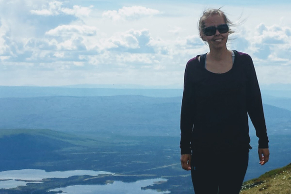 JSGS master’s student Lauren Wallingham stands on top of Mount Haldane in the Traditional Territory of the First Nation of Na-Cho Nyak Dun in the Yukon. (Photo: Submitted)