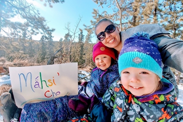 Lauren Wallingham with her two children holding a Northern Tutchone sign that translates to “Thank You”. (Photo submitted)