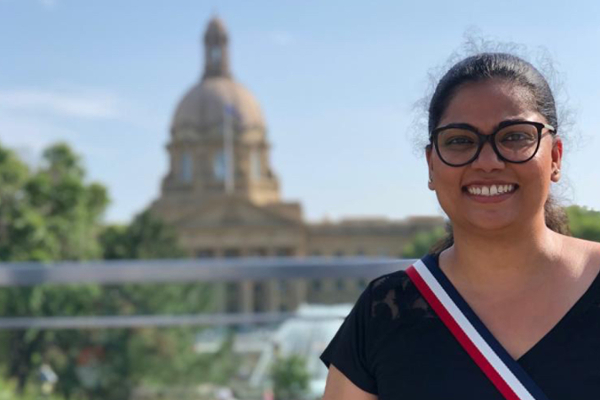 Jovita Dias, JSGS graduate, outside of the legislative building in Edmonton, Alberta. 